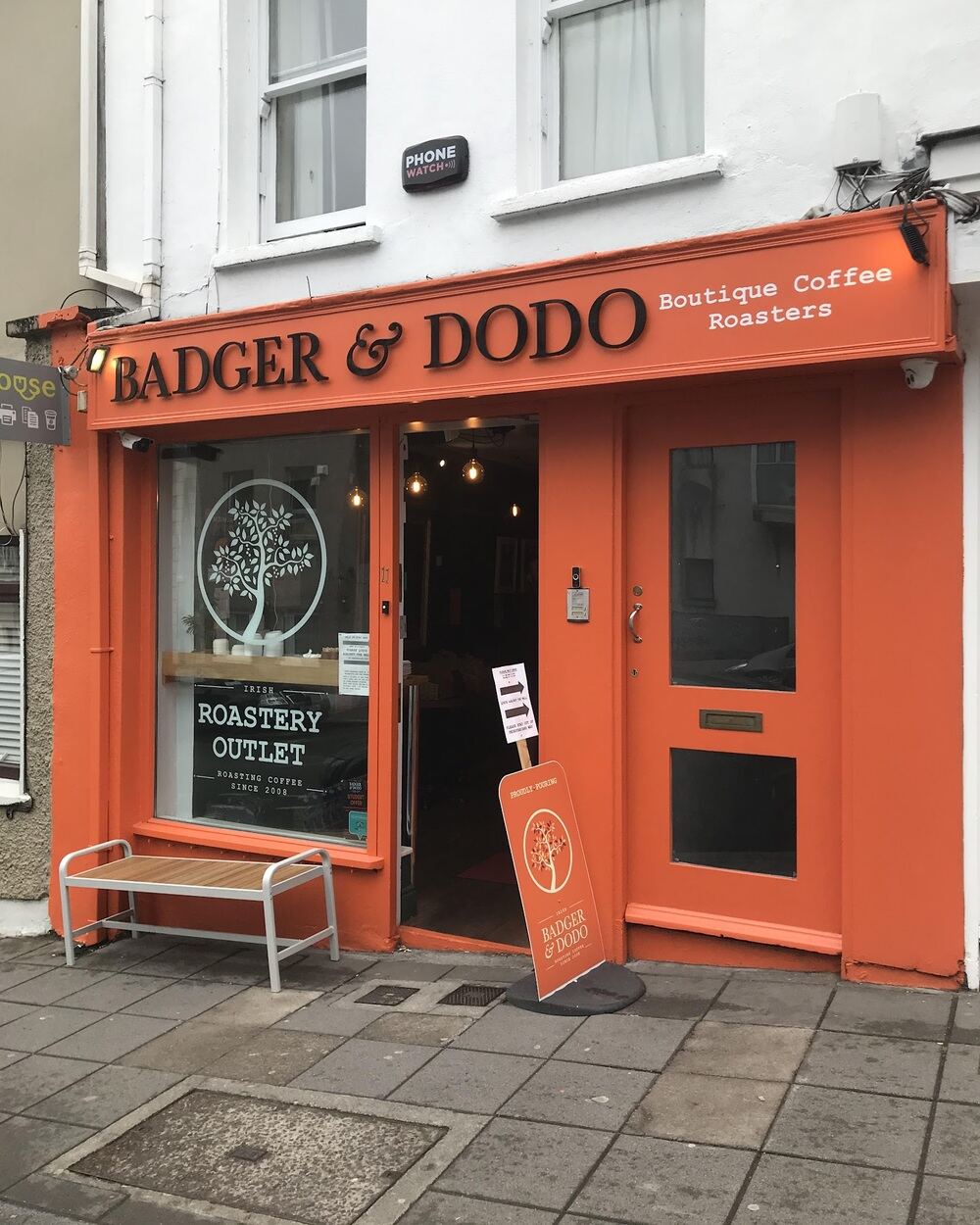 The shopfront at 11 Barrack St, Cork: orange fascia, Badger & Dodo lettering and a tree logo on the window